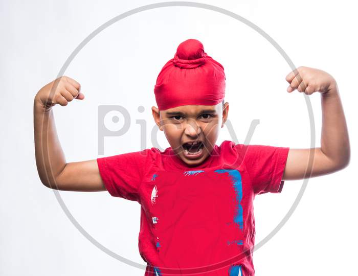 Indian sikh/punjabi little boy showing strength