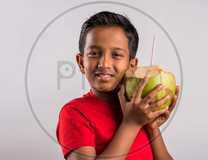 Small boy drinking coconut water / nariyal pani