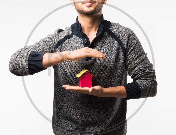 man with house or real estate model