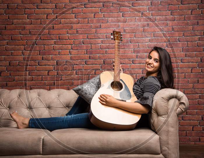 Attractive young girl with Guitar