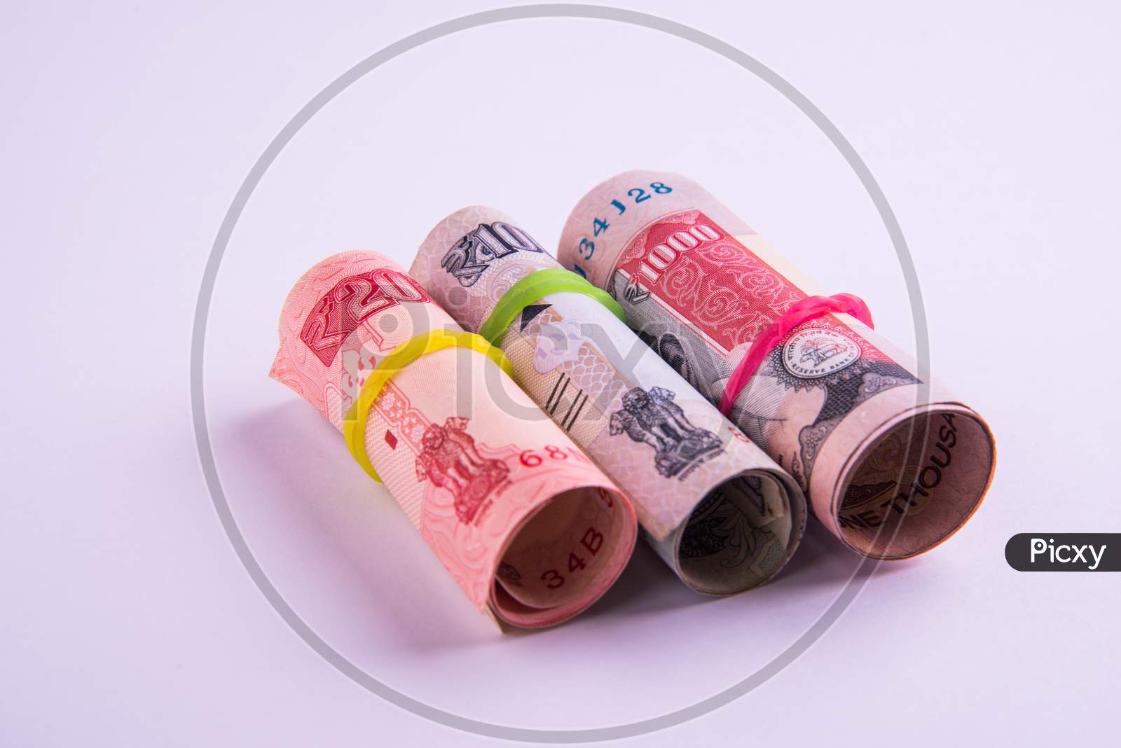 Roll of indian rupees with rubber band isolated on white background