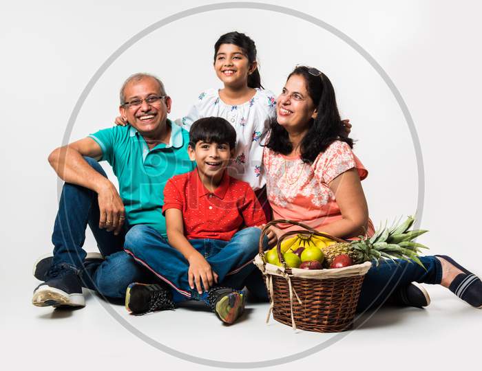 Kids with grandparents sitting over white background