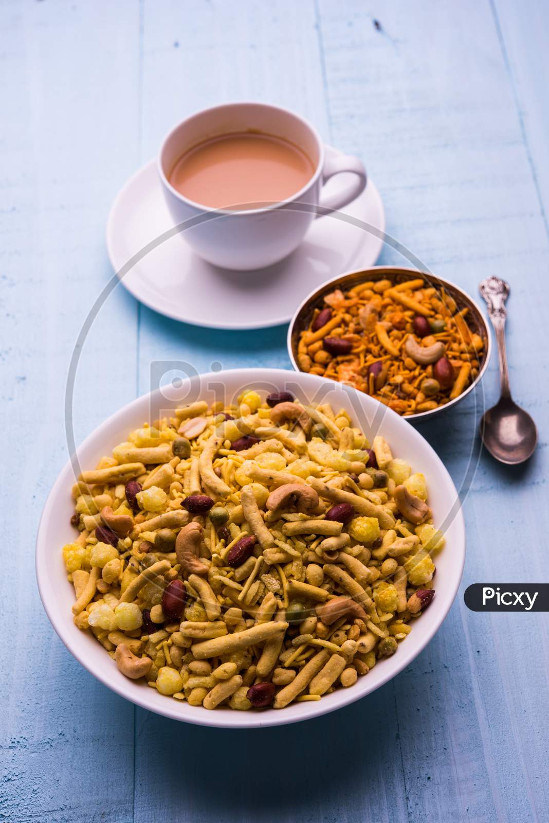 indian famous snack called Farsan or chivada or chakna with hot tea