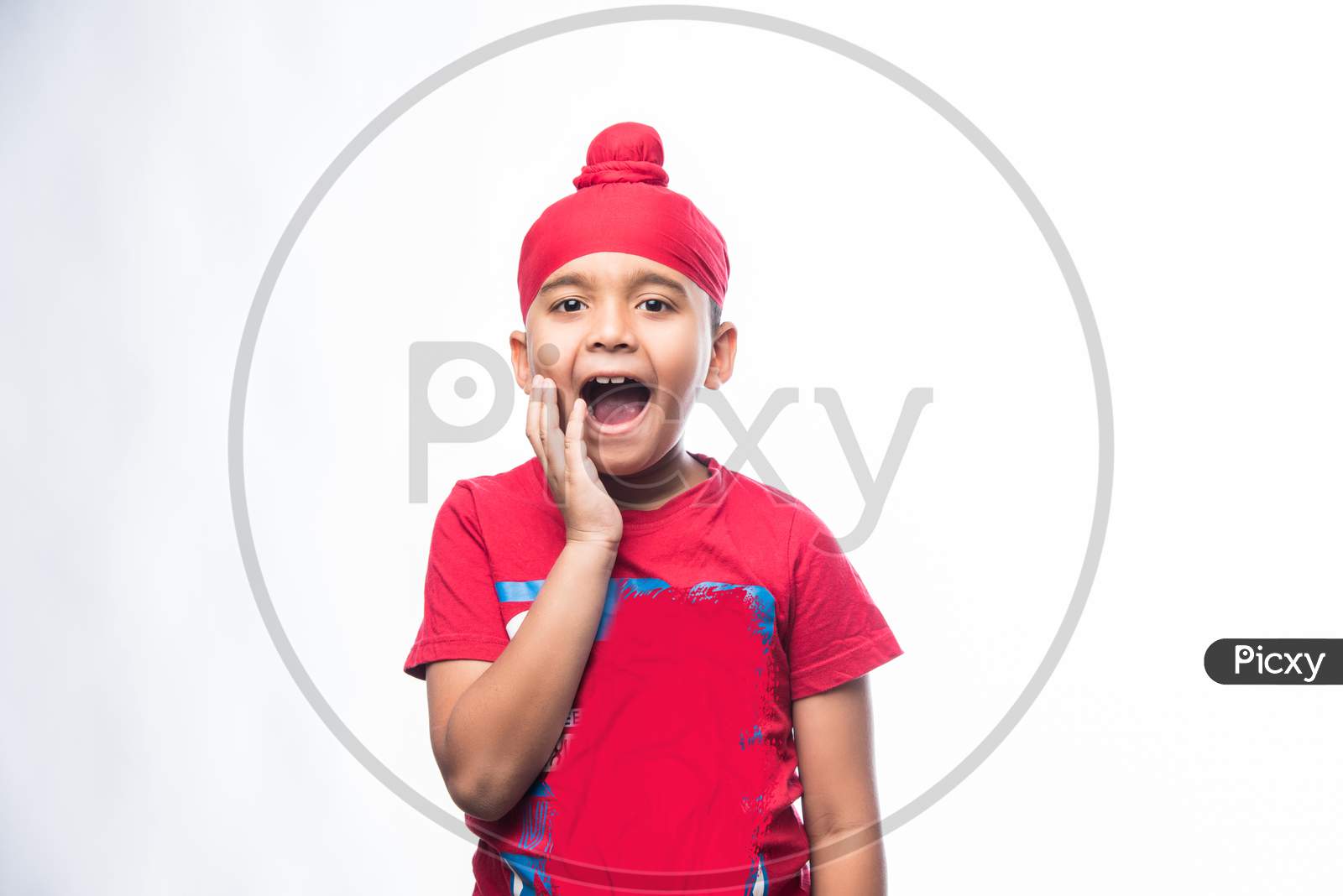 Portrait of Indian Sikh/punjabi little boy standing isolated over white background
