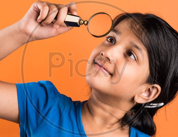 small School girl with magnifying glass