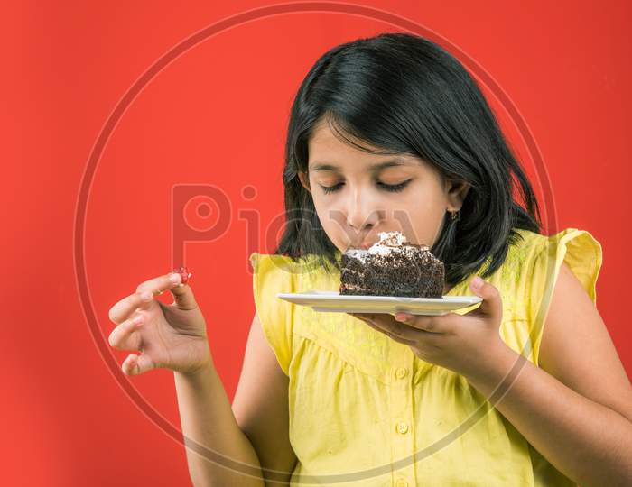 Small Girl eating cake / pastry