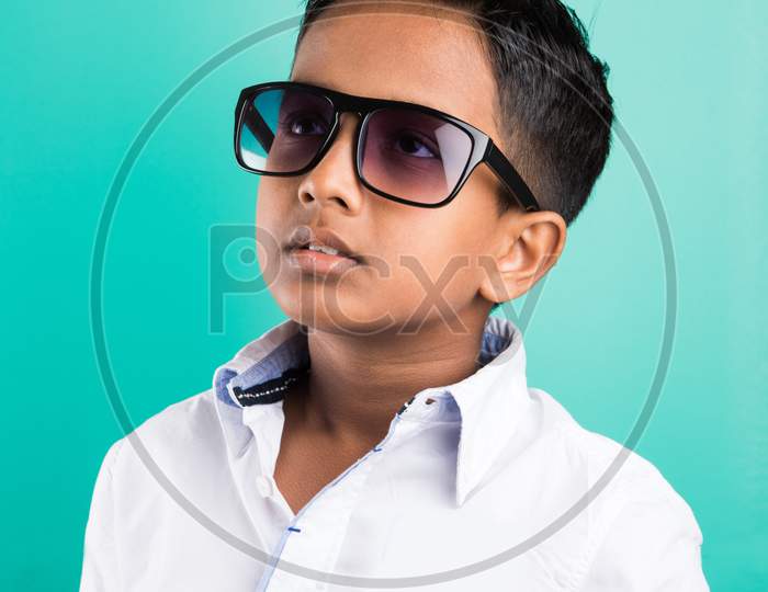 Little indian boy wears goggle / dark glasses / sun glasses