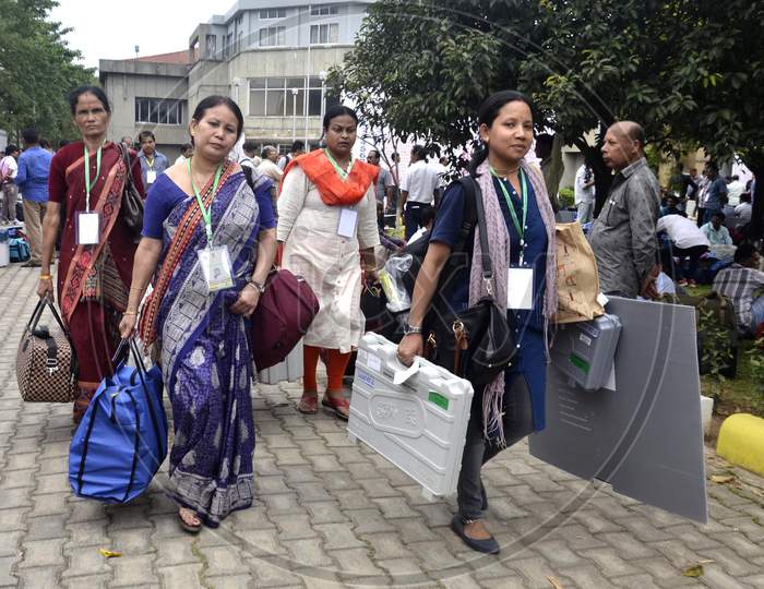 Women Polling officials leave after collecting Electronic Voting Machines (EVM)