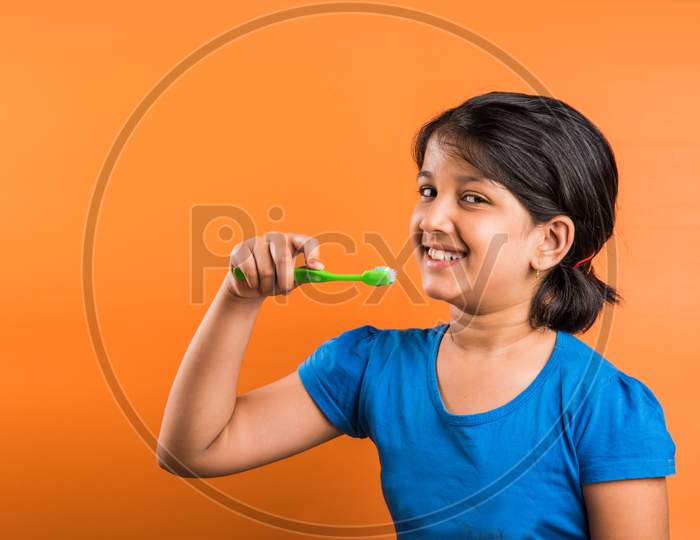 Small girl child brushing teeth