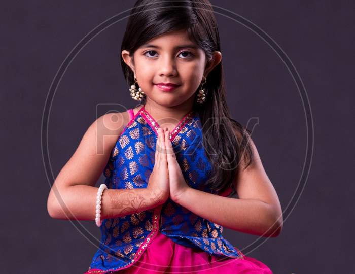 Small girl in namaskara or Prayer pose with both hands folded