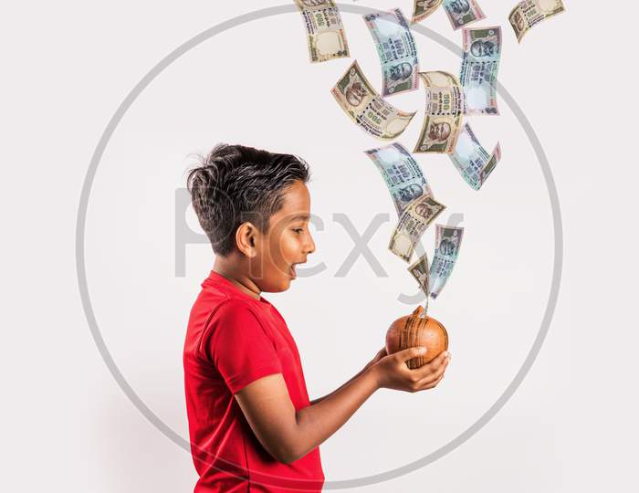 Indian kid catching falling currency notes