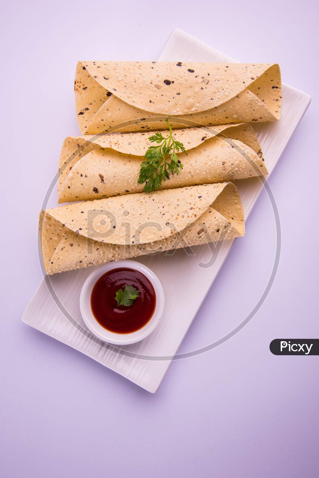 Roasted papad roll is a popular side dish In Indian Lunch/Dinner