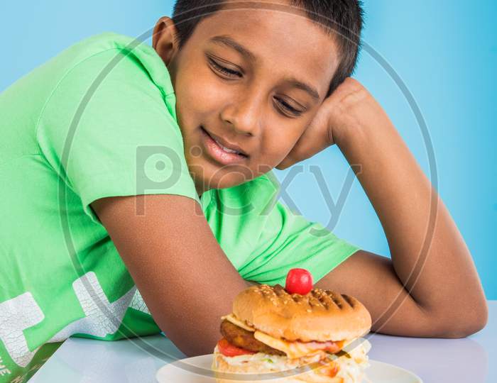 little boy eating burger