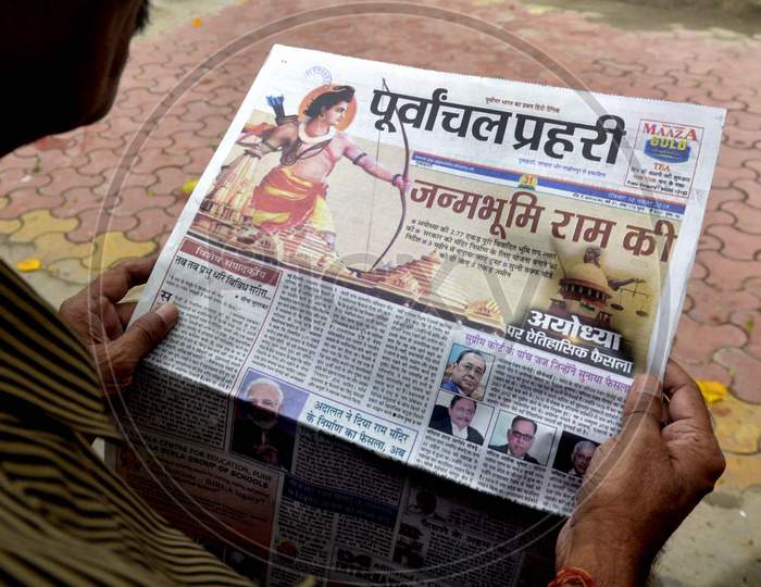 A senior Citizen  read newspapers fronted with headlines on Ayodhya case verdict