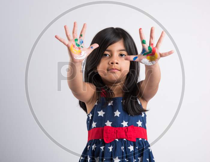 Indian cute girl with colourful palm over white background