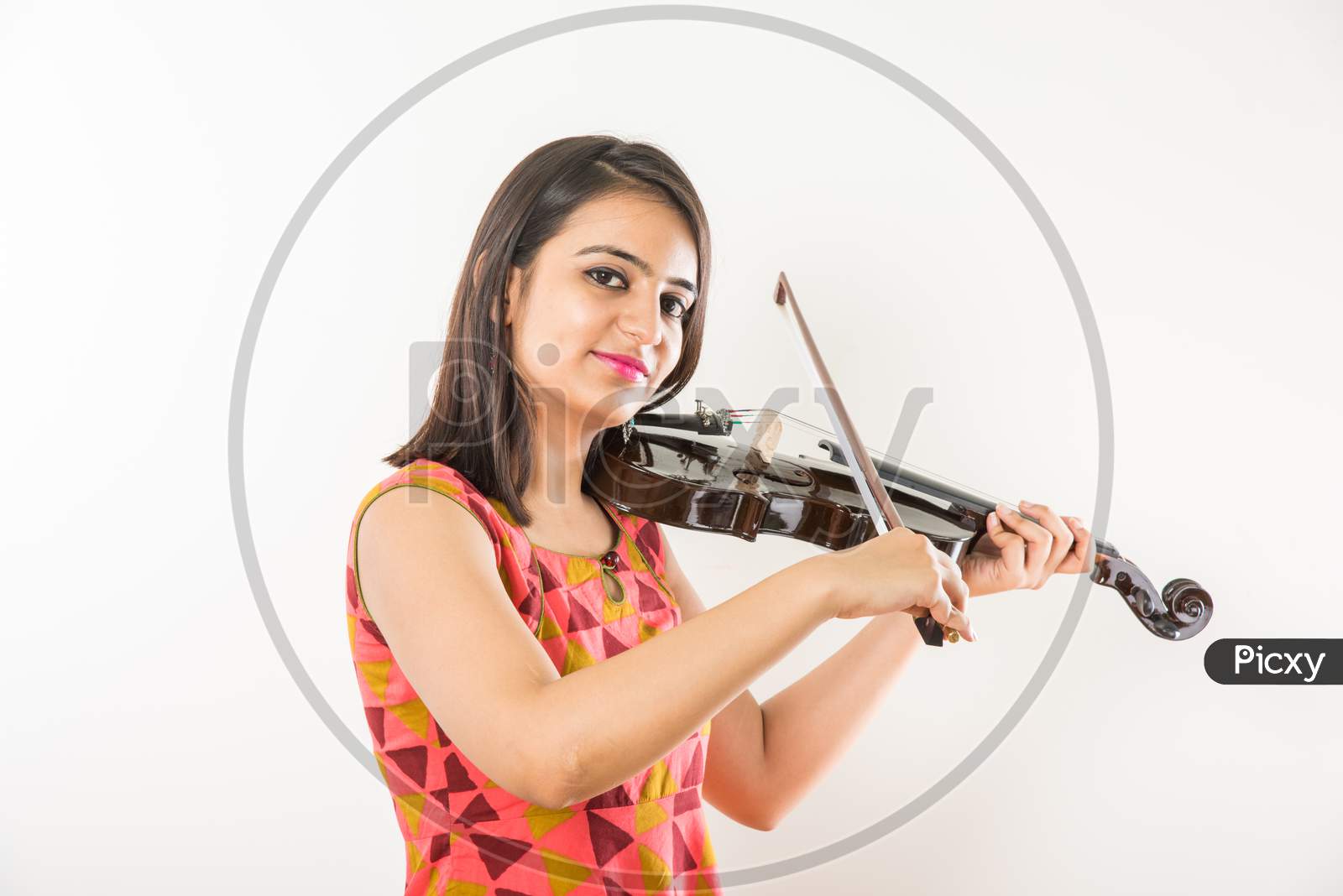Pretty Indian/Asian young Girl musician playing Violin against white background