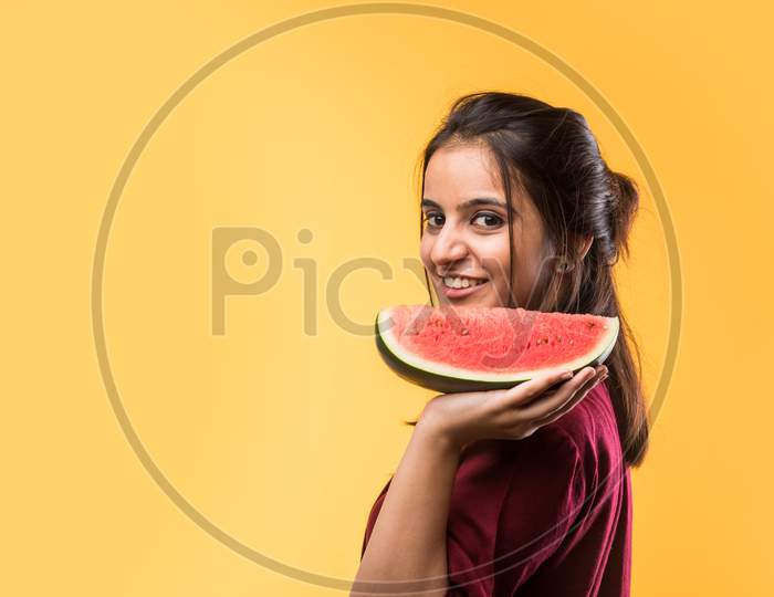 Young beautiful girl eating watermelon / tarbuj fruit