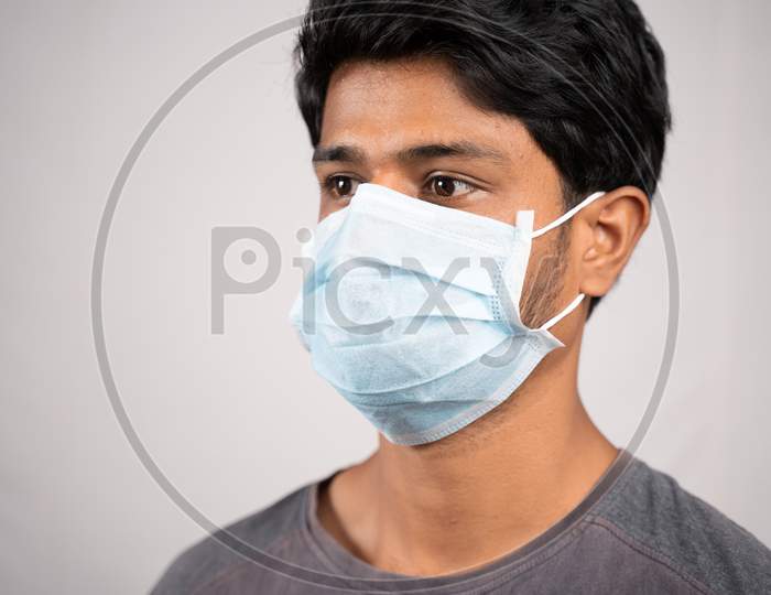 Young Man Properly Covered Nose And Mouth With Face Mask - Awareness And Safety Concept To Ware Mask Properly, To Protect From Coronavirus Or Covid-19 Crisis On Isolated Background.