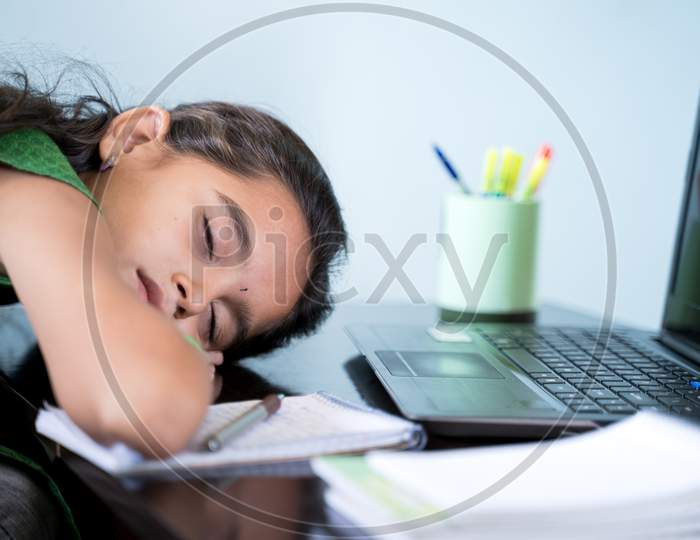 Bored Girl Child Slept Infront Of Laptop - Concept Of Kid Tired From E-Learning Or Online Education At Home During Covid-19 Or Coronavirus Outbreak.