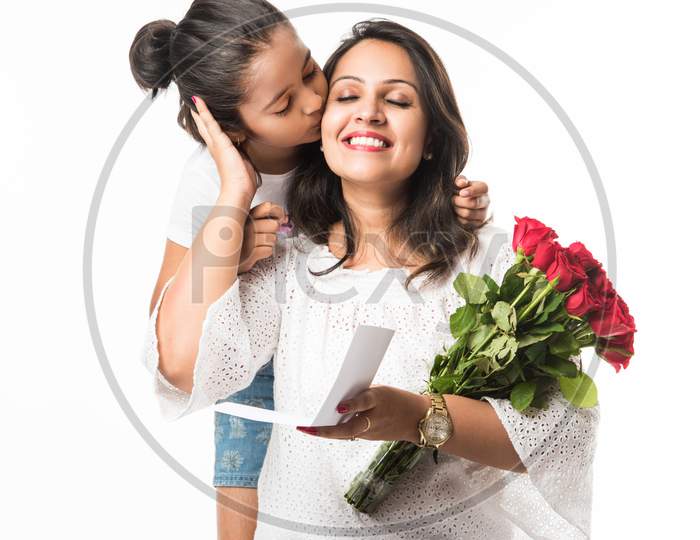 Mother's Day, mother and daughter with rose bouquet and greeting card