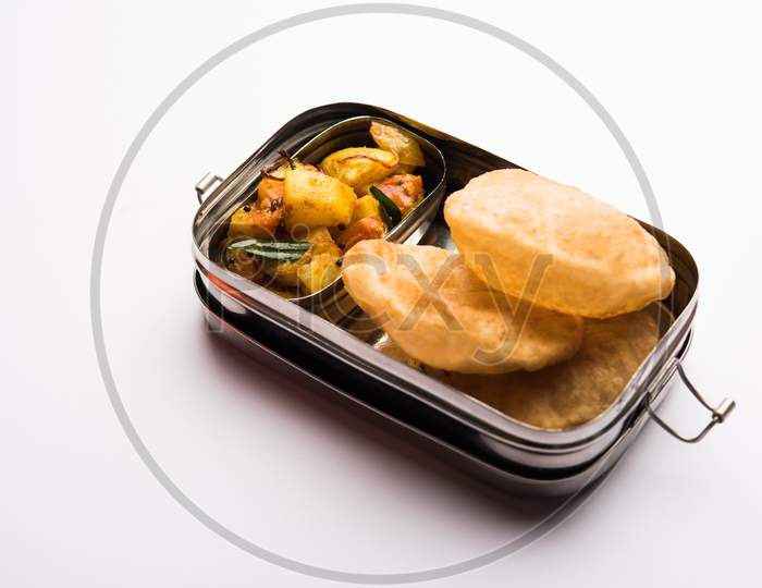 Lunch Box / Tiffin for Indian kids, includes hot poori/puri with potato / aloo sabzi, selective focus