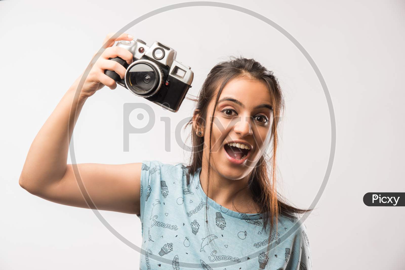 Young beautiful indian girl holding antique Photography camera