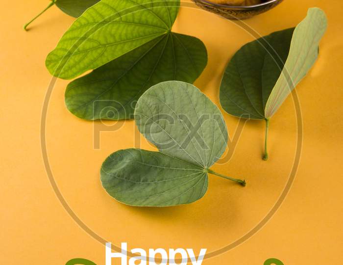 happy Dussehra / Ayudh Puja greeting card with Pedha /Pera and Apta Leaf