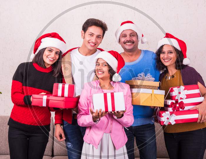Indians celebrating Christmas or Xmas with family indoors