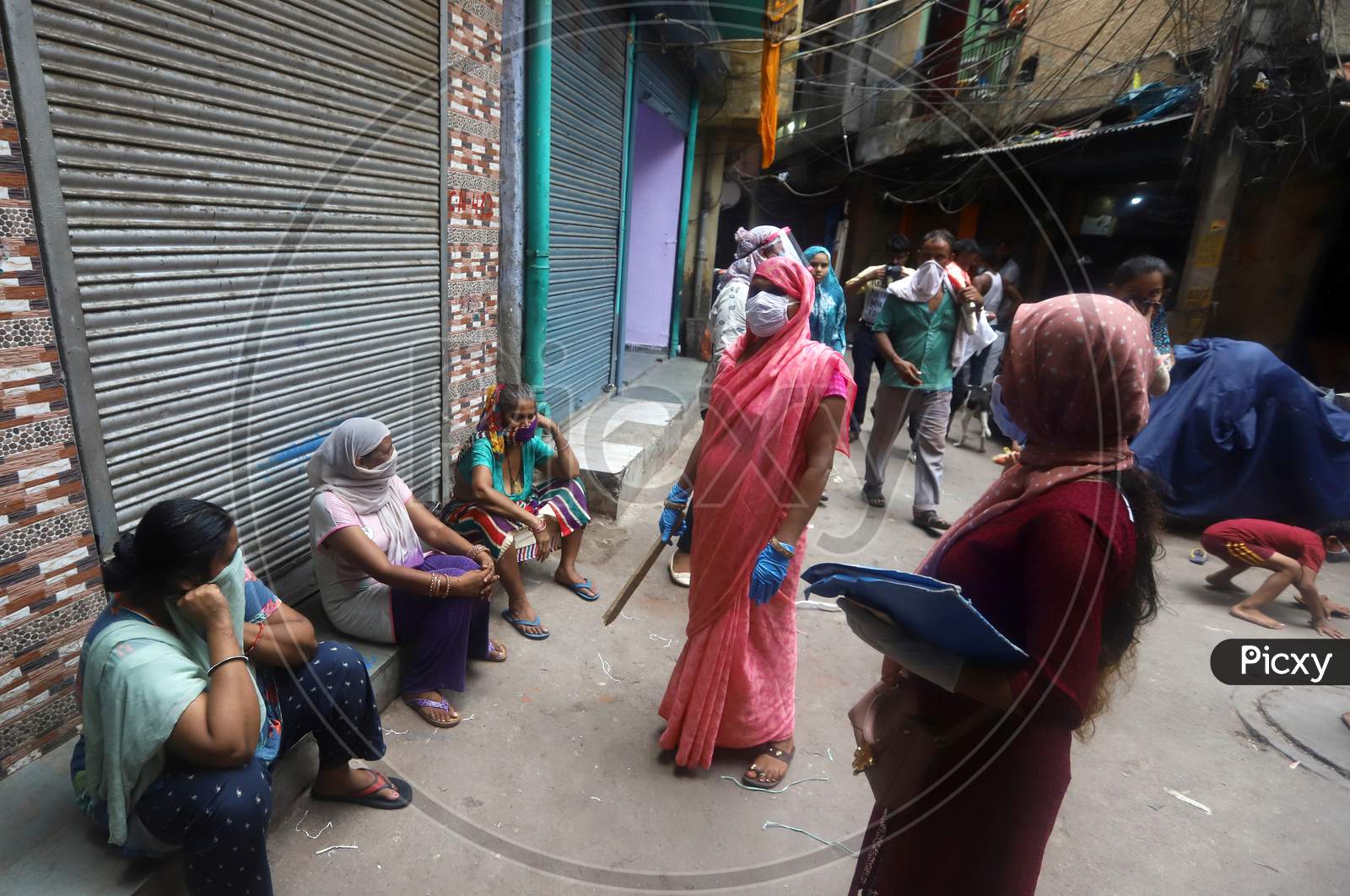 Health workers educating people on the importance of maintaining social distancing in a containment zone in Nabi Karim Area, New Delhi on July 06, 2020