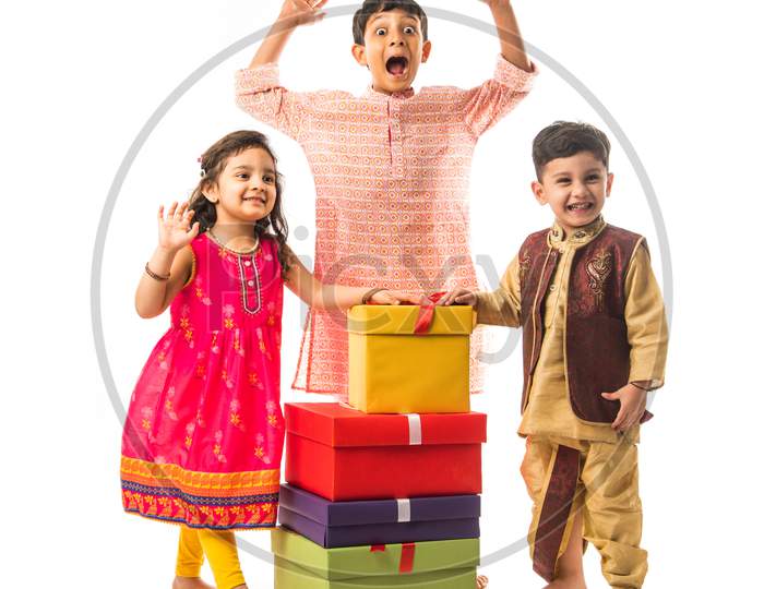 Cute little Indian Kids with gift boxes, standing isolated over white background