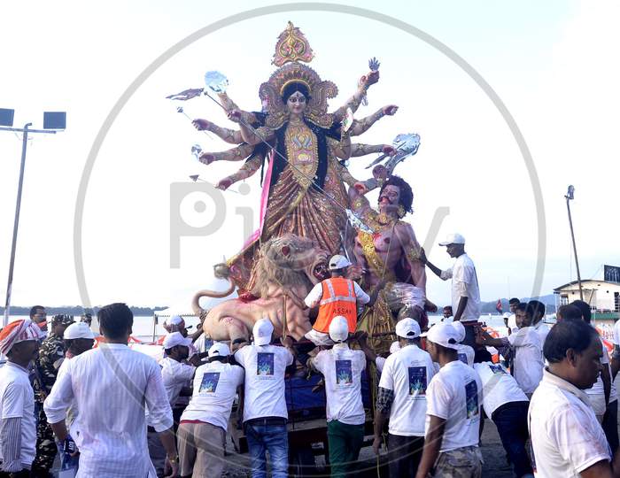 Municipal workers carry an idol of Hindu goddess Durga