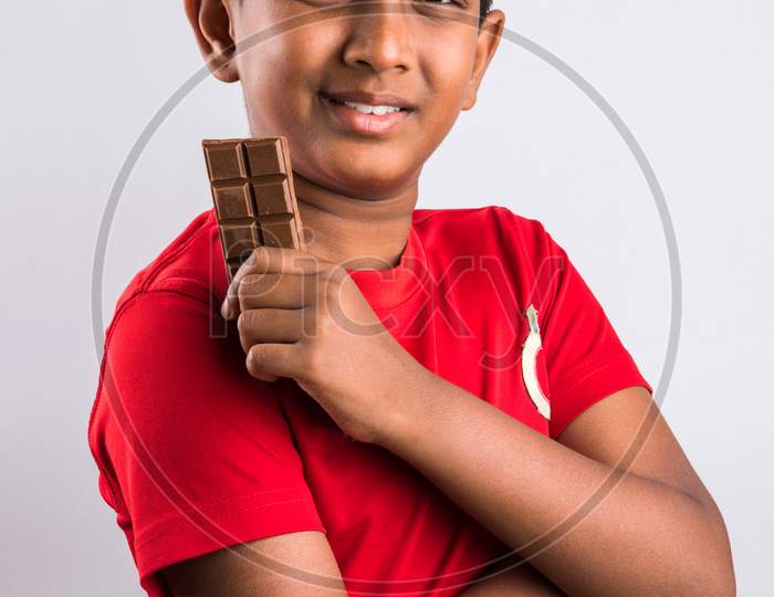 Small boy eating chocolate