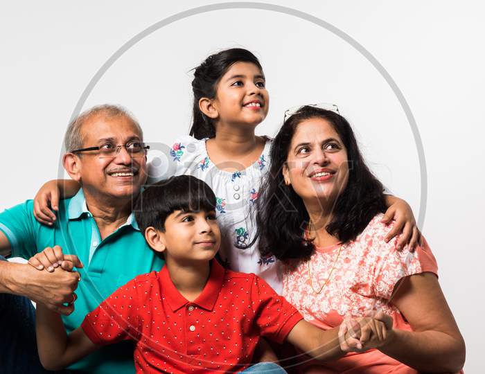 Kids with grandparents sitting over white background