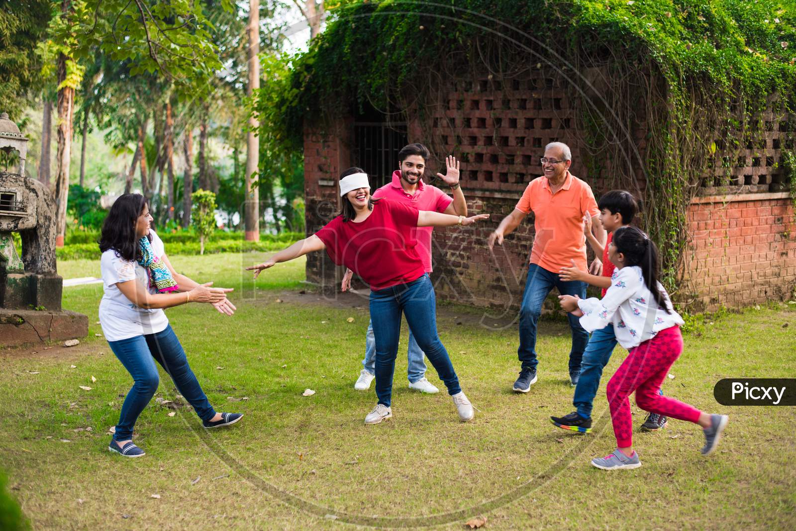 Indian Family playing blindfold game in park or garden