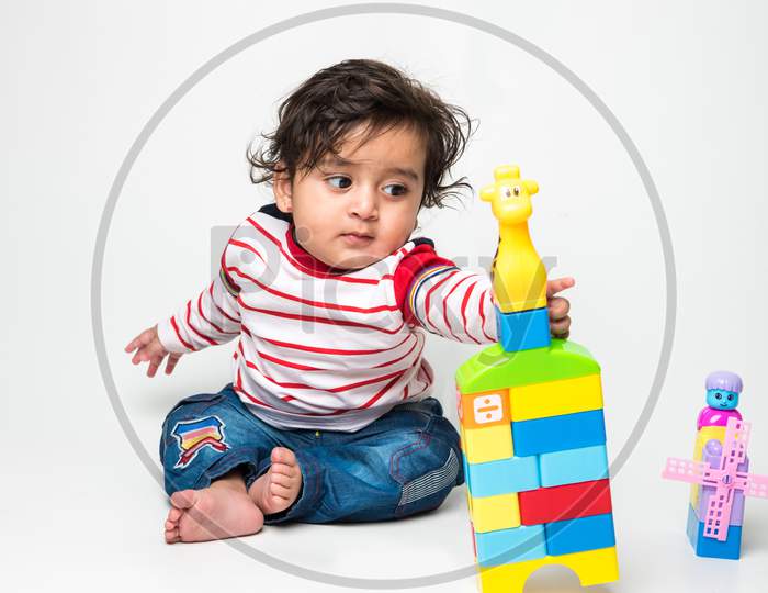 cute little Indian baby boy playing with toys
