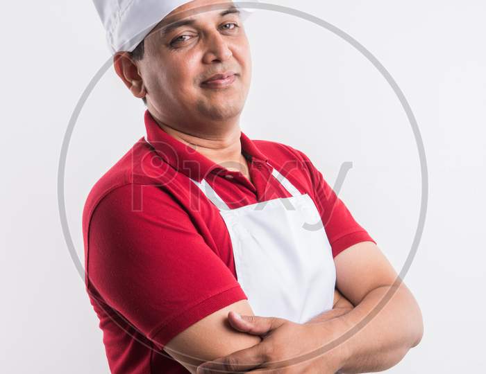 Indian Male Chef / cook in apron and wearing hat