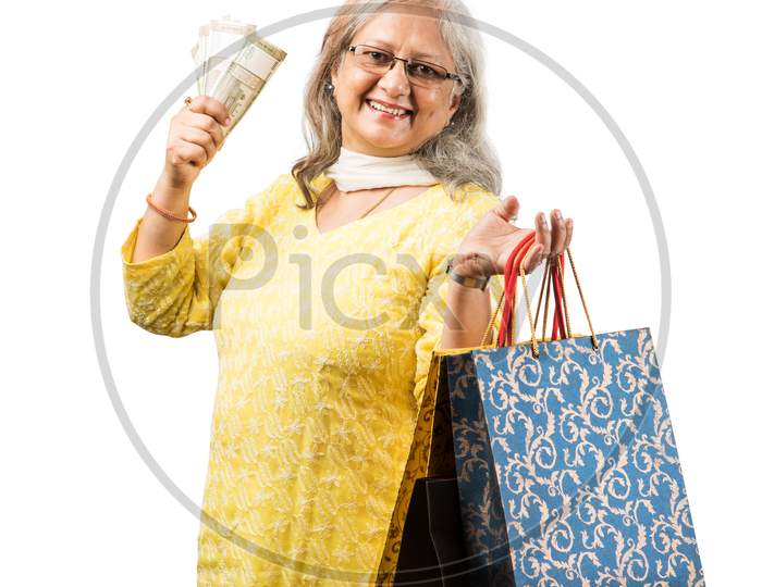 Senior woman and grand daughter - real estate concept with money
