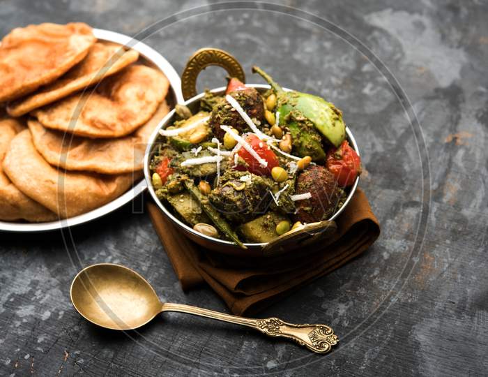 Undhiyu is a Gujarati mixed vegetable dish, specialty of Surat, India. Served in a bowl with or without poori