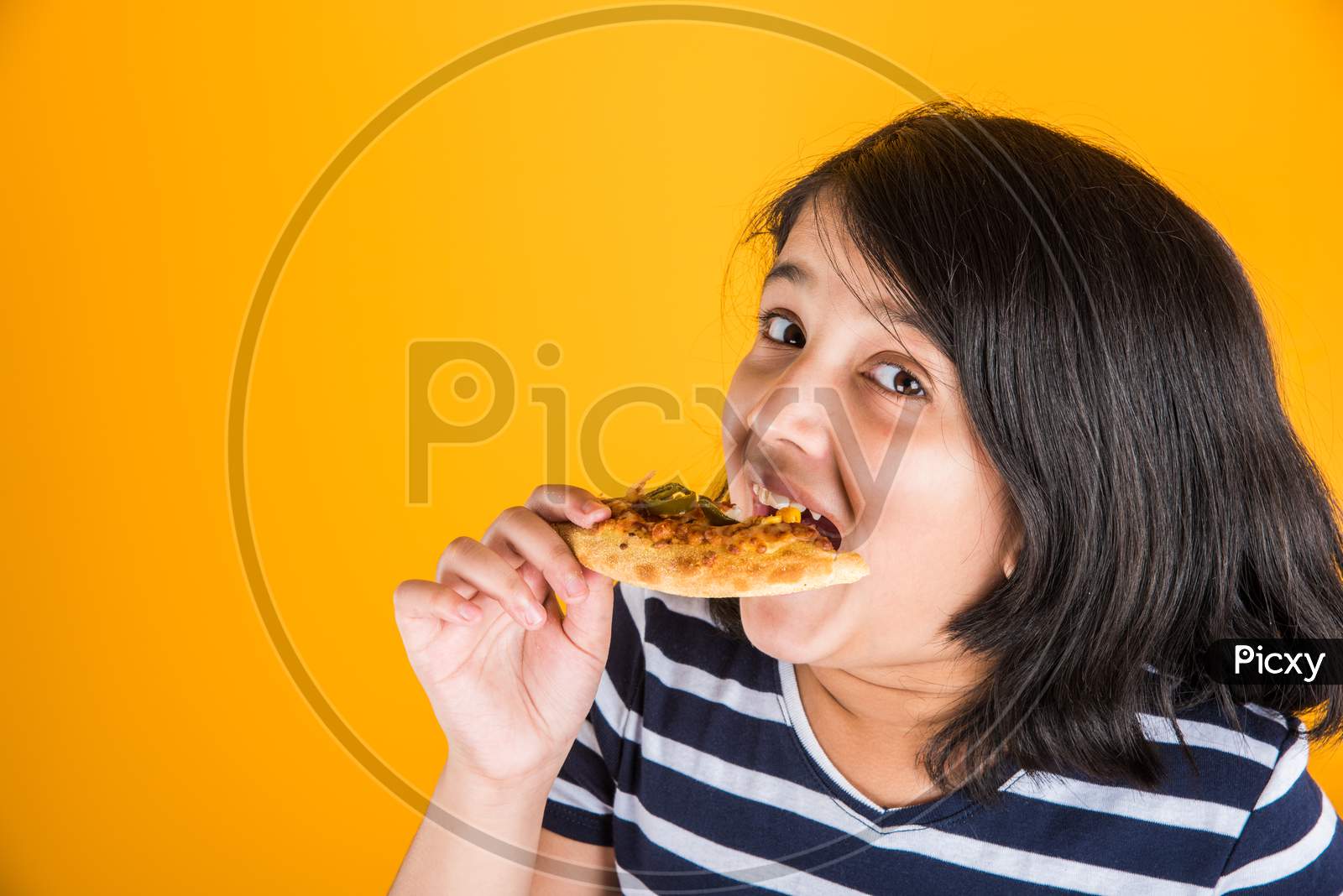Cute little girl eating pizza