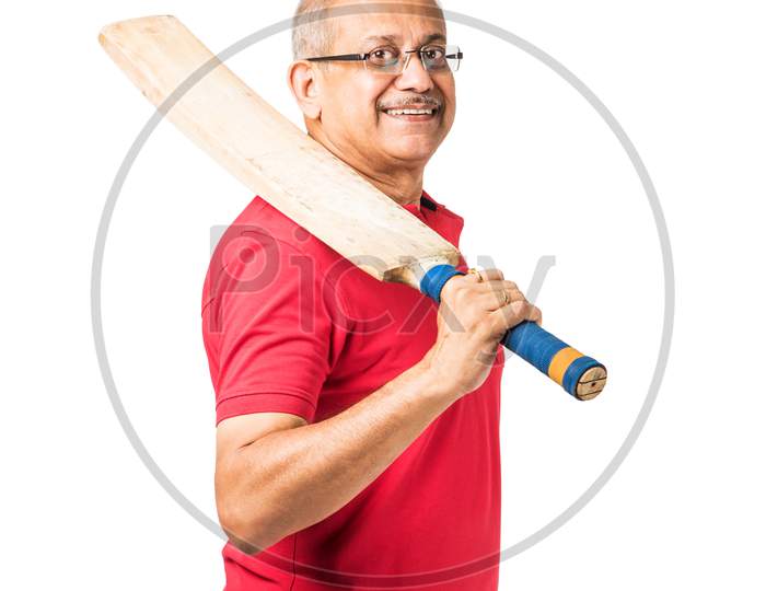 Senior indian man playing cricket with bat