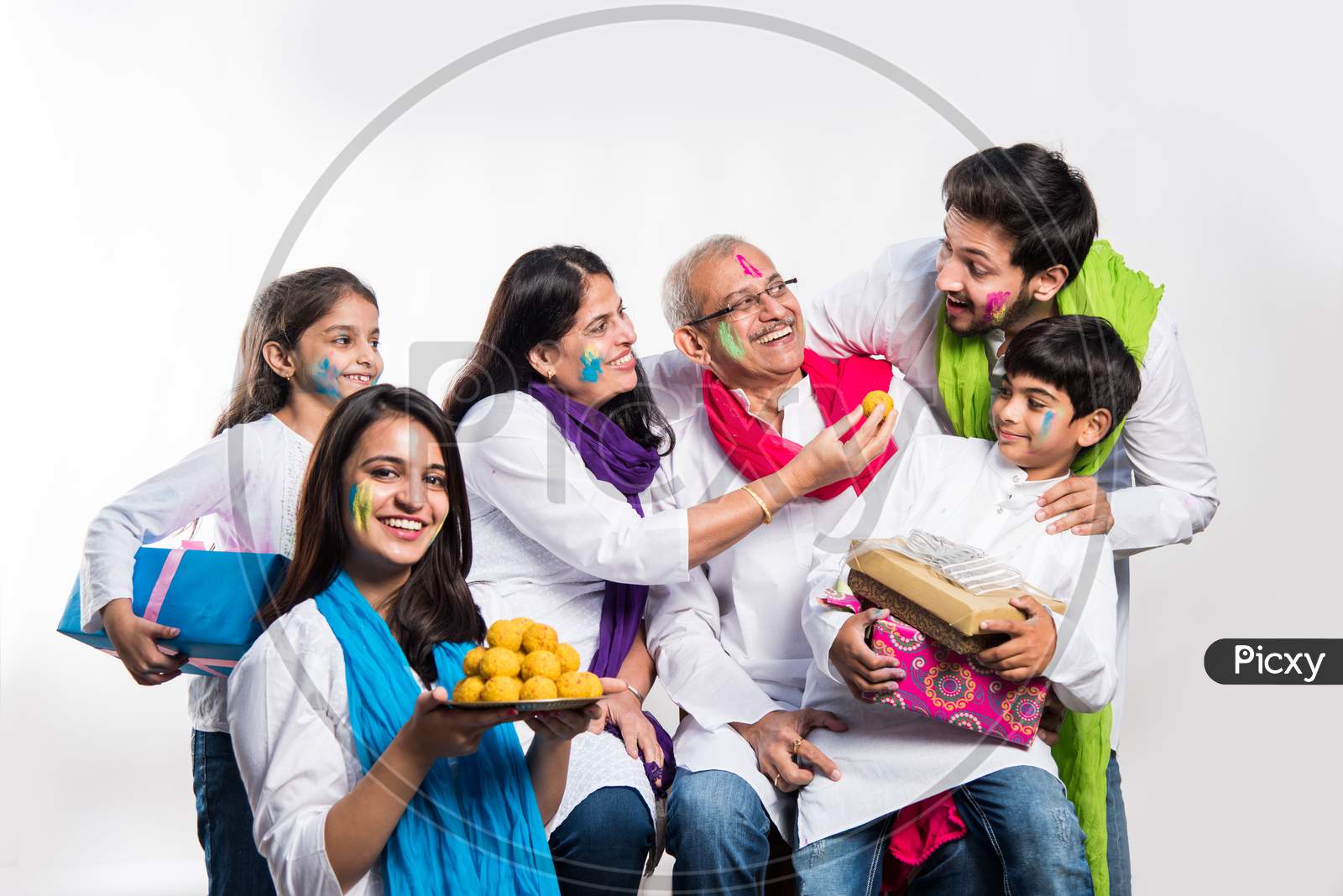 Family eating sweet laddu on Holi festival