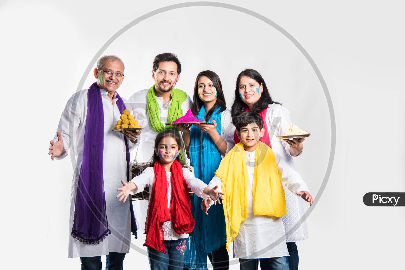 Indian Family playing holi posing for group photo over white background