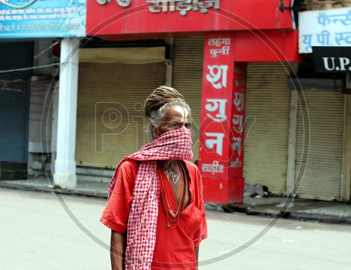 A hermit walks in a market during the lockdown in Prayagraj, Uttar Pradesh on July 11, 2020