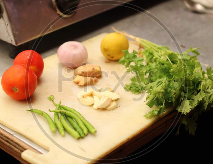Making chutney with coriander, green chillies, garlic, Ginger, lemon, onion and some tomato