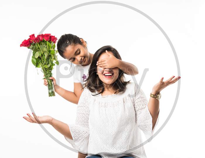 Mother's Day, mother and daughter with rose bouquet and greeting card