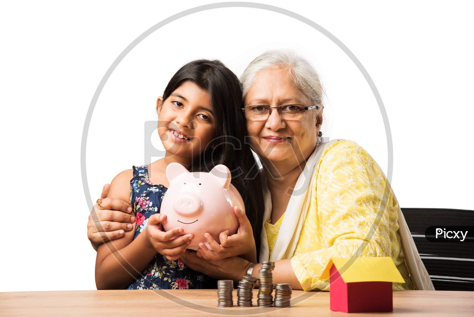 Senior woman and grand daughter - real estate concept with money