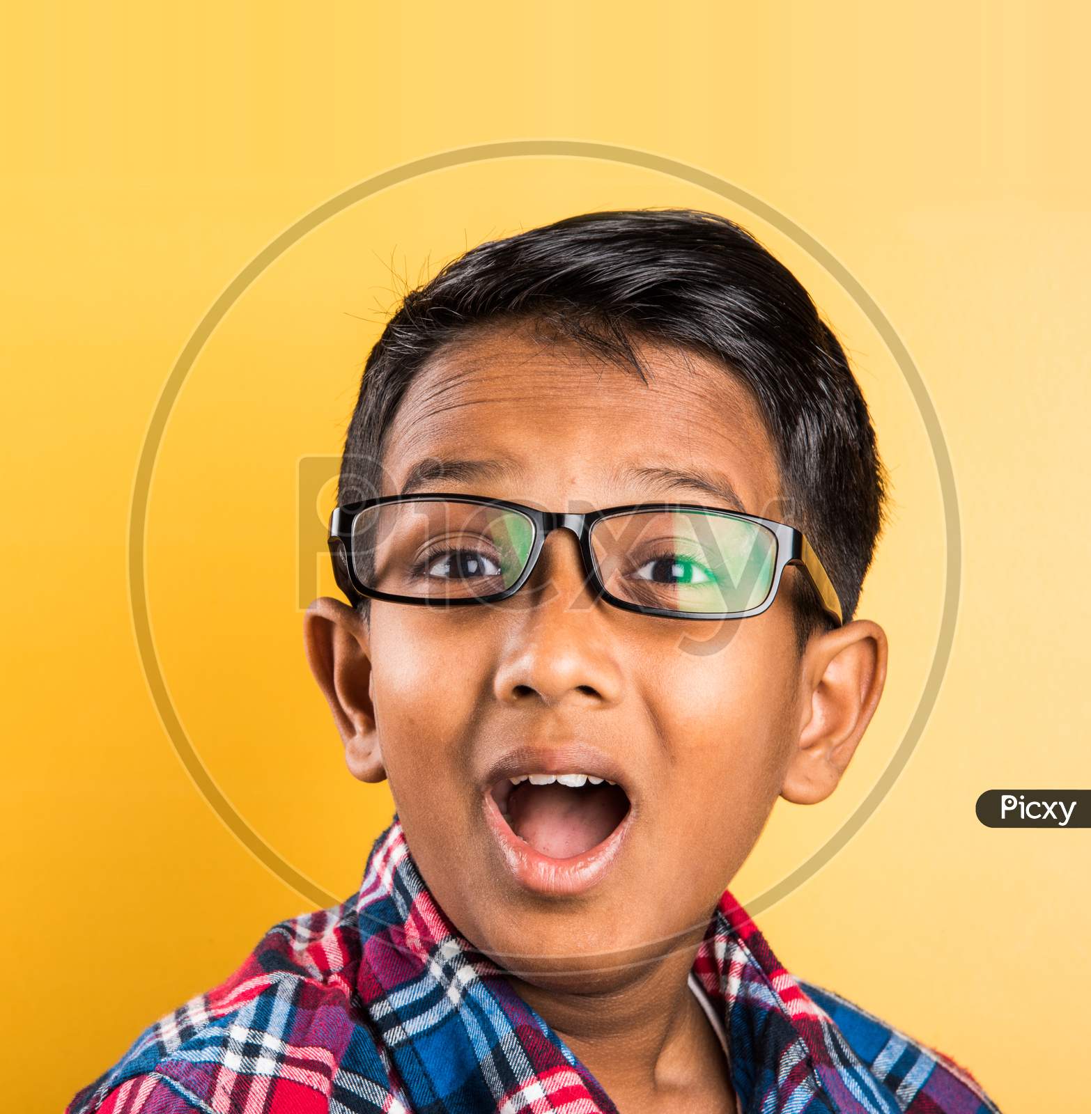 Small boy wears clear eye glasses or spectacles