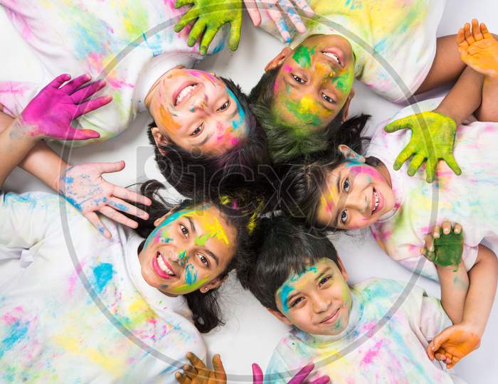 Kids playing with Holi colours