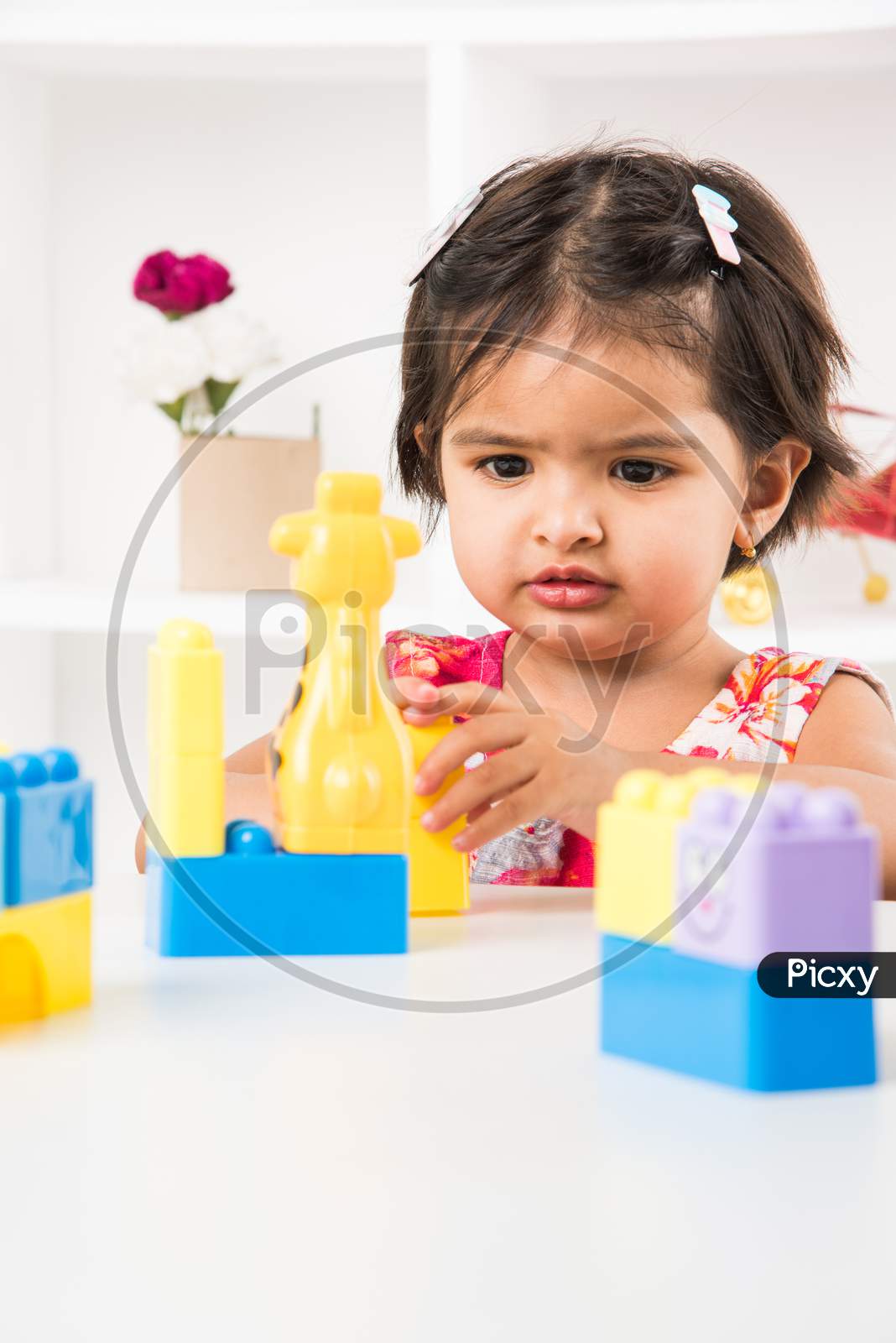 Little girl playing with colourful toys