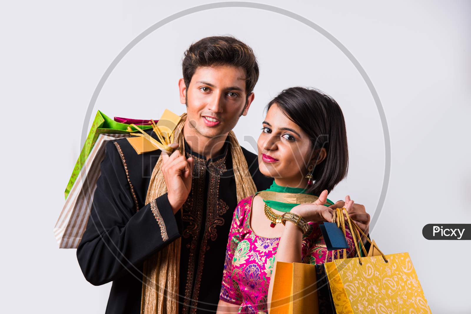 Indian young couple holding shopping bags